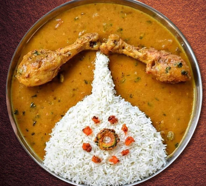 Durga Puja thali decorated with chicken curry and rice