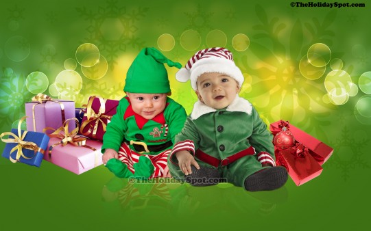 Two babies dressed as elves greeting christmas