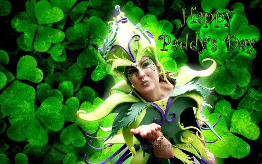 A woman dressed in green outfit wishing Happy Paddys Day wallpaper.