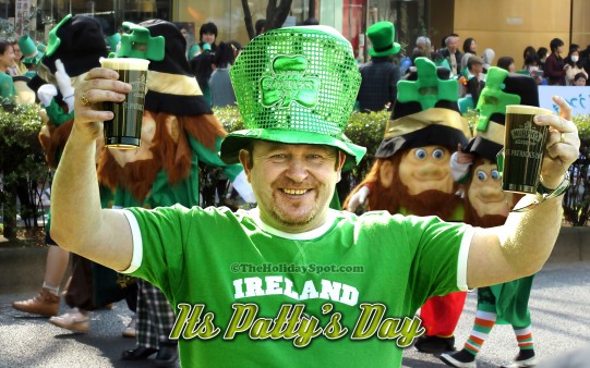 A man cheering for the St. Patricks Day occasion.